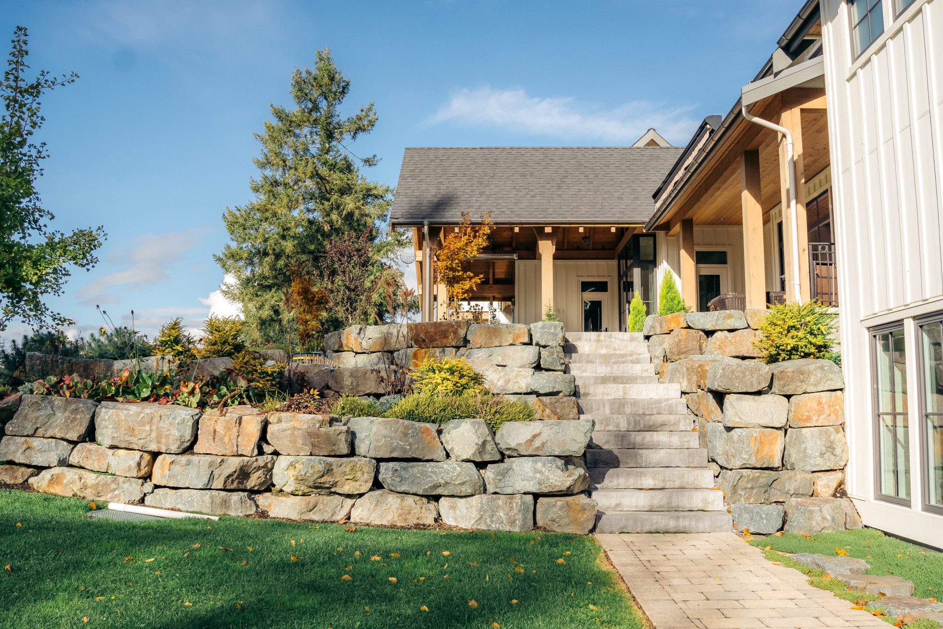 custom home with landscaping using natural materials