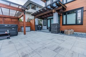 outdoor living space with patio, hot tub and seating